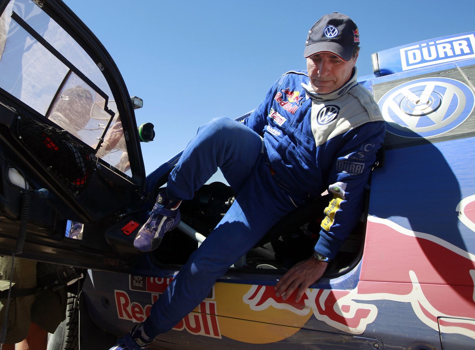 Carlos Sainz of Spain leaves his car as he finishes the tenth stage of the third South American edition of the Dakar Rally 2011 from Copiapo to Chilecito