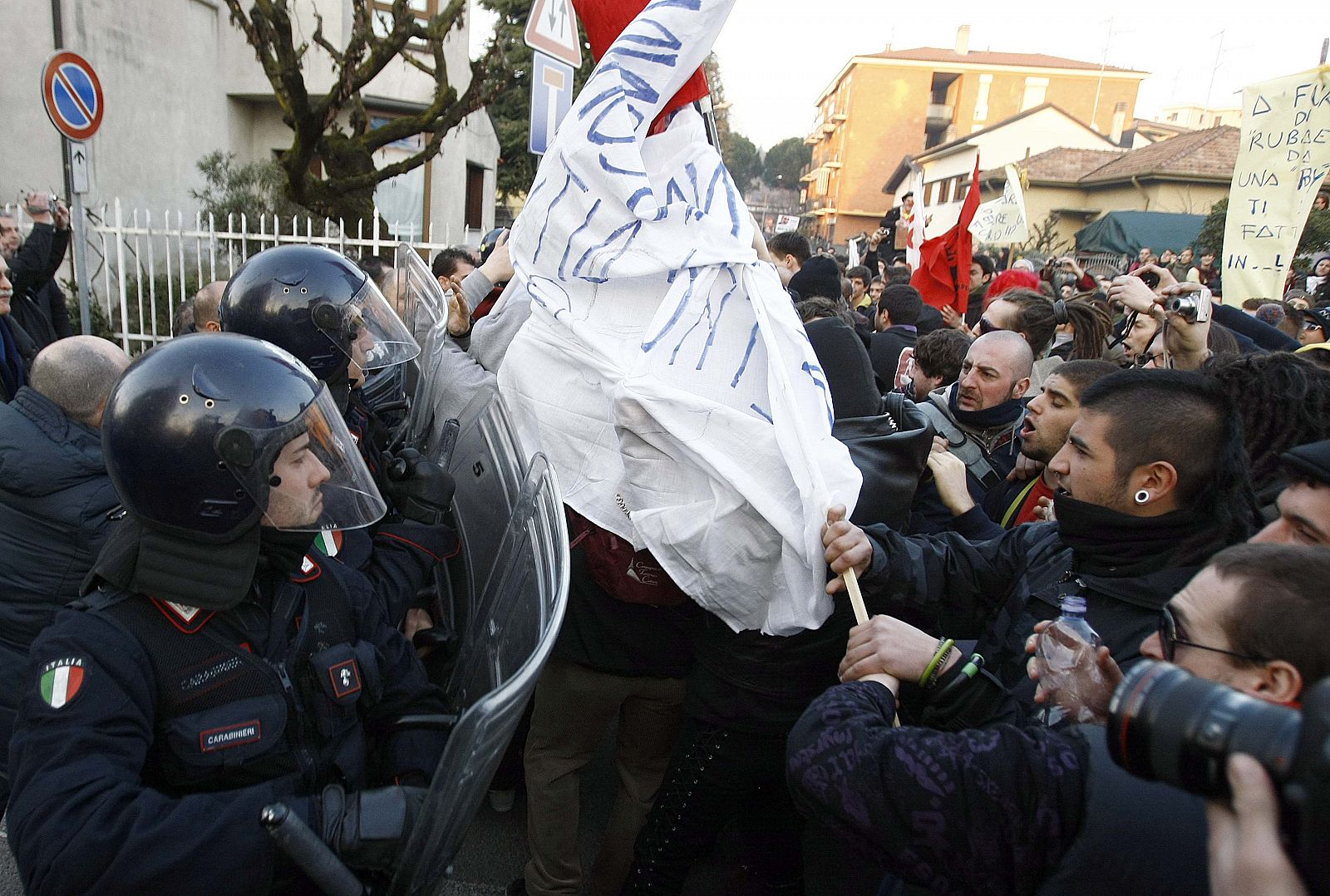Demonstrators fight with police during a protest against Italian Prime Minister Silvio Berlusconi in Arcore