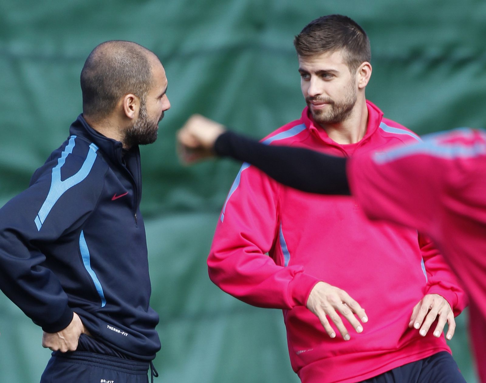 Barcelona's Guardiola talks to Pique during a training session at Ciutat Esportiva Joan Gamper
