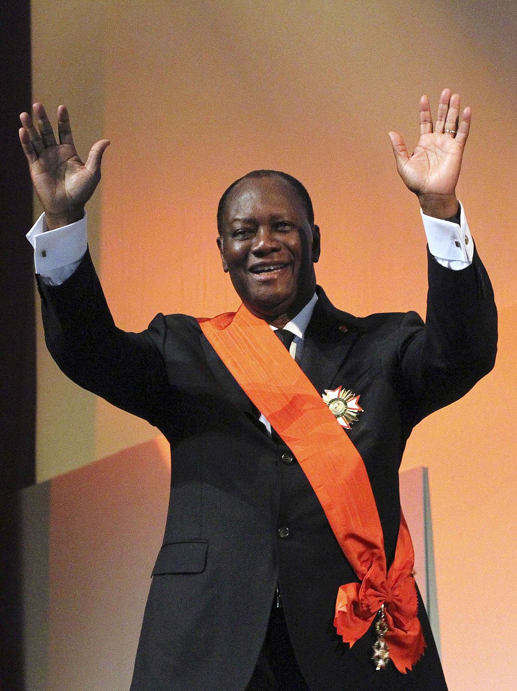 Ivory Coast President Alassane Ouattara waves during his inauguration ceremony at the Felix Houphouet-Boigny Foundation in Yamoussoukro