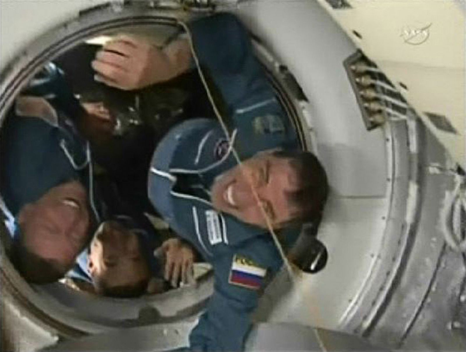 Expedition 28 Flight Engineers Mike Fossum, Sergei Volkov and Japan Aerospace Agency astronaut Satoshi Furukawa emerge from the hatch of their Soyuz spacecraft.