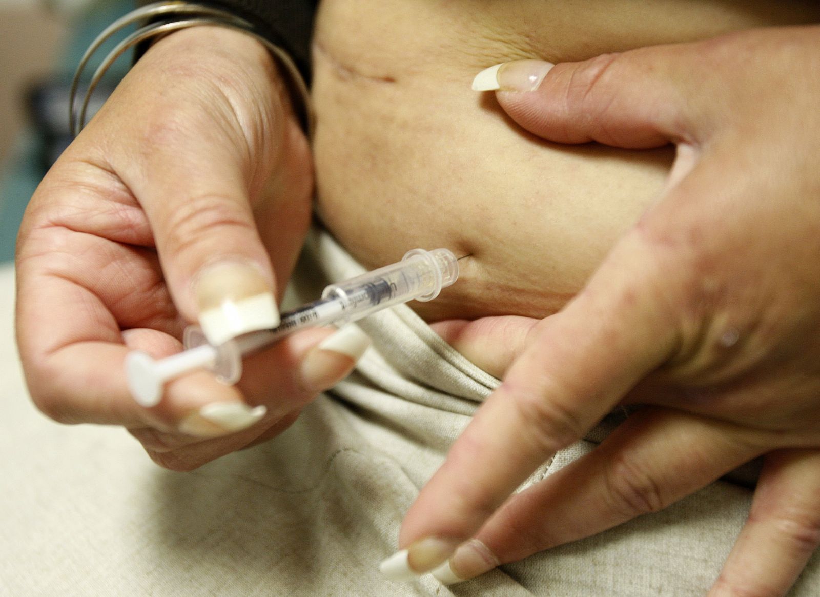 File photo of diabetic Khachatoorian injecting herself with insulin at the J.W.C.H. safety-net clinic in downtown Los Angeles