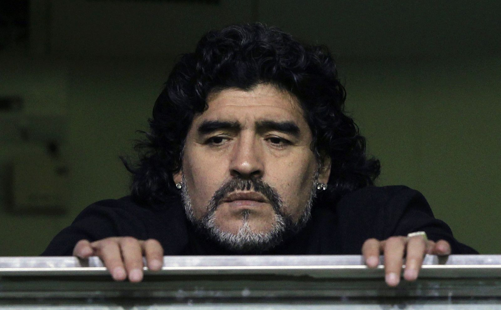 Former Argentine soccer star Maradona watches from a balcony the Argentine first division soccer match between Boca Juniors and Banfield in Buenos Aires