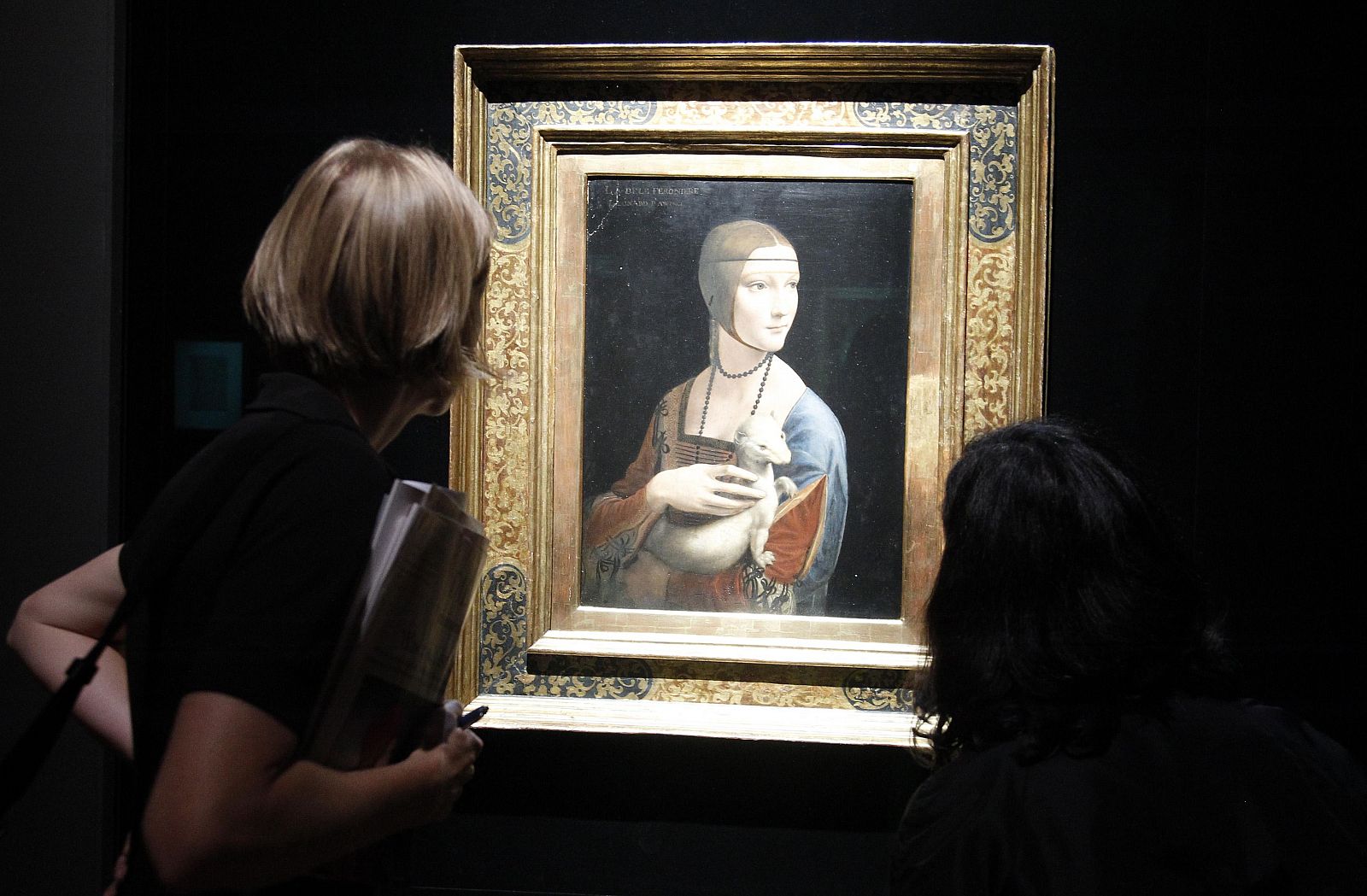 Journalists look at painting "Dame mit dem Hermelin" by Leonardo da Vinci at Bode museum in Berlin
