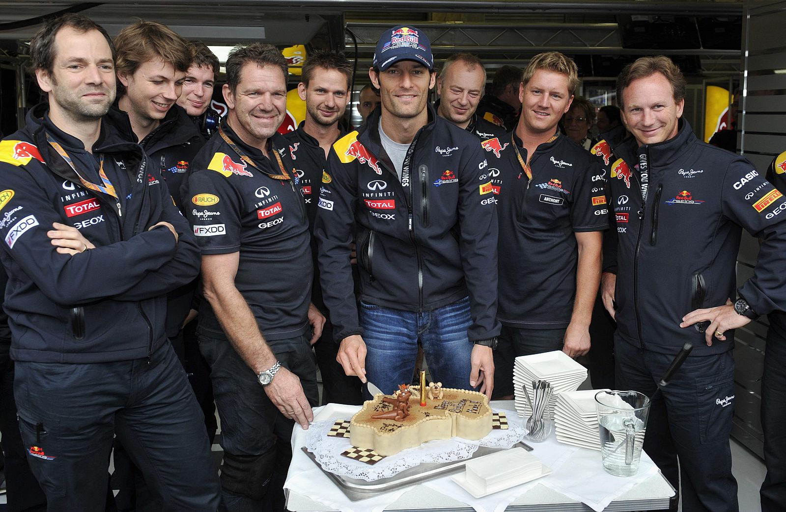 Red Bull Formula One driver Webber of Australia celebrates his 35th birthday before the third practice session of the Belgian F1 Grand Prix in Spa-Francorchamps
