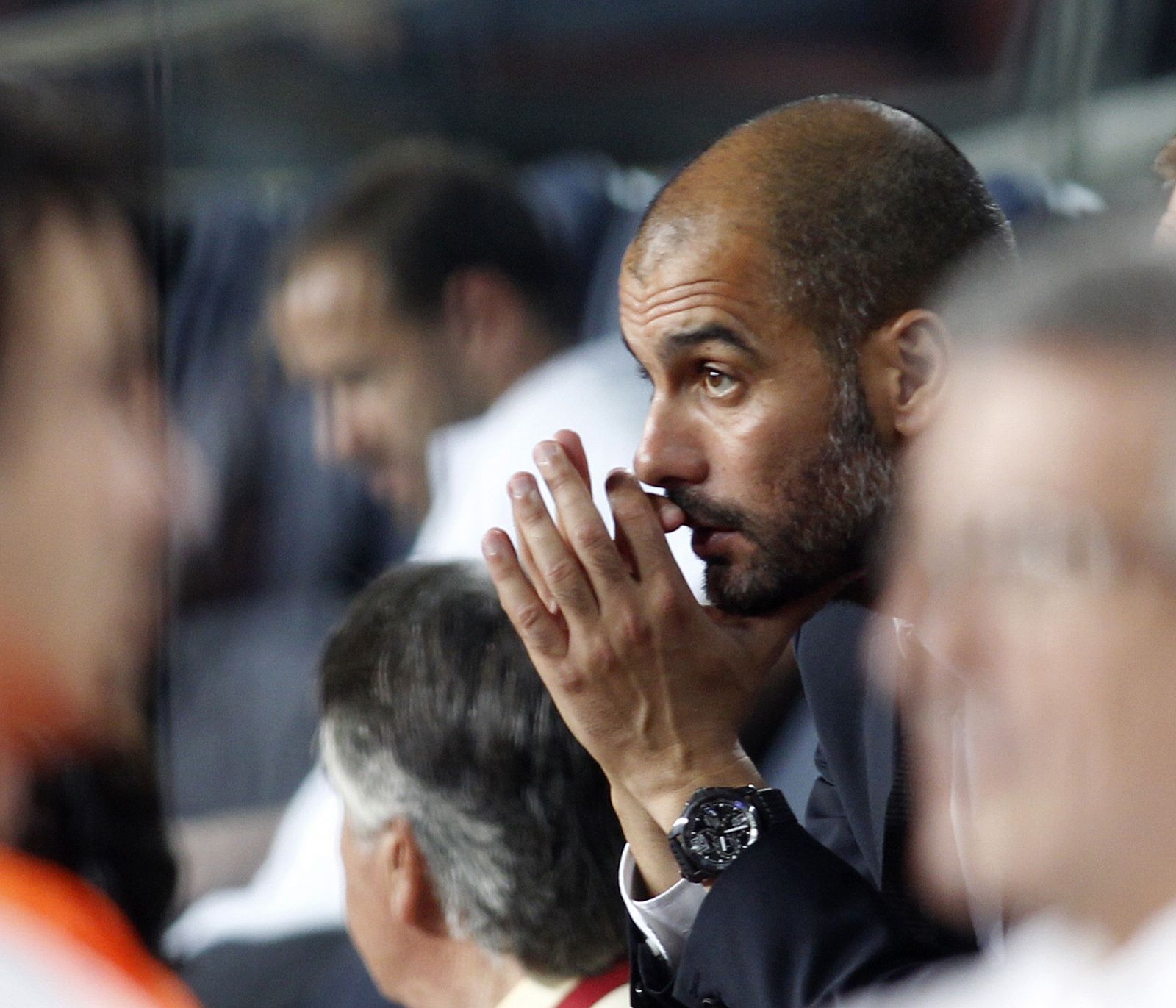 Barcelona's coach Pep Guardiola sits on the bench as he watches Lionel Messi's third goal against Osasuna in Barcelona