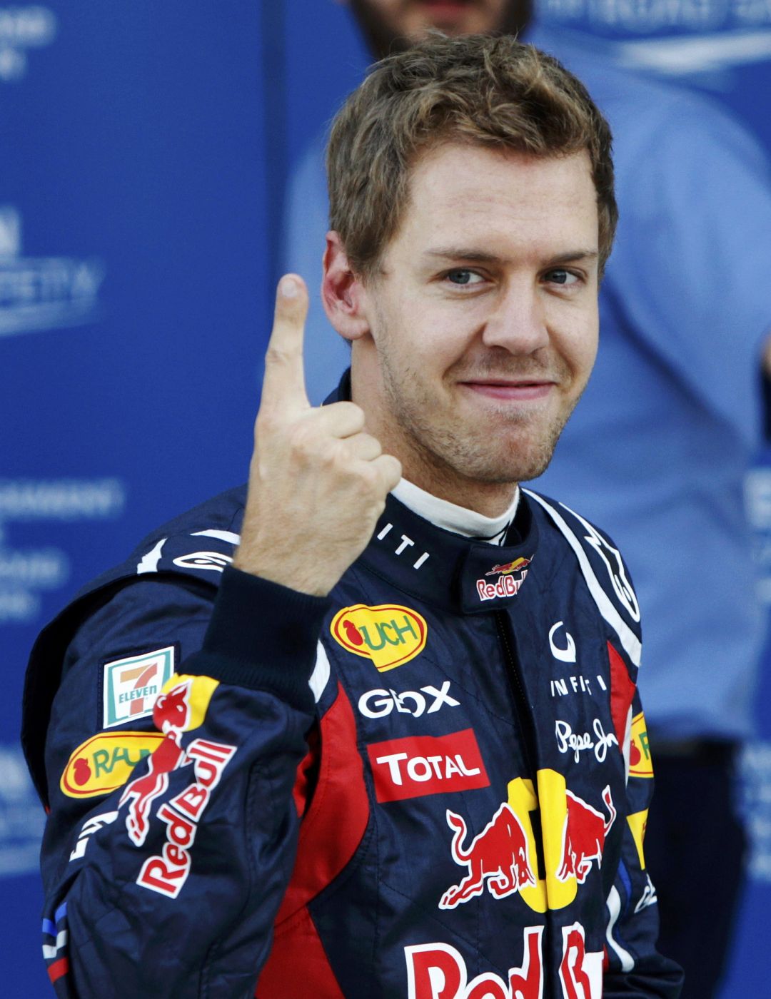 Red Bull Formula One driver Vettel celebrates taking the pole position after the qualifying session of the Japanese F1 Grand Prix at the Suzuka circuit