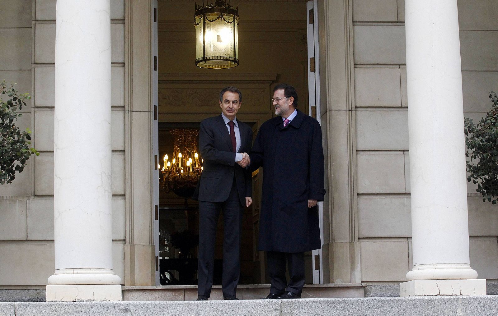 Spain's outgoing PM Jose Luis Rodriguez Zapatero shakes hands with incoming PM Mariano Rajoy during a meeting in Madrid