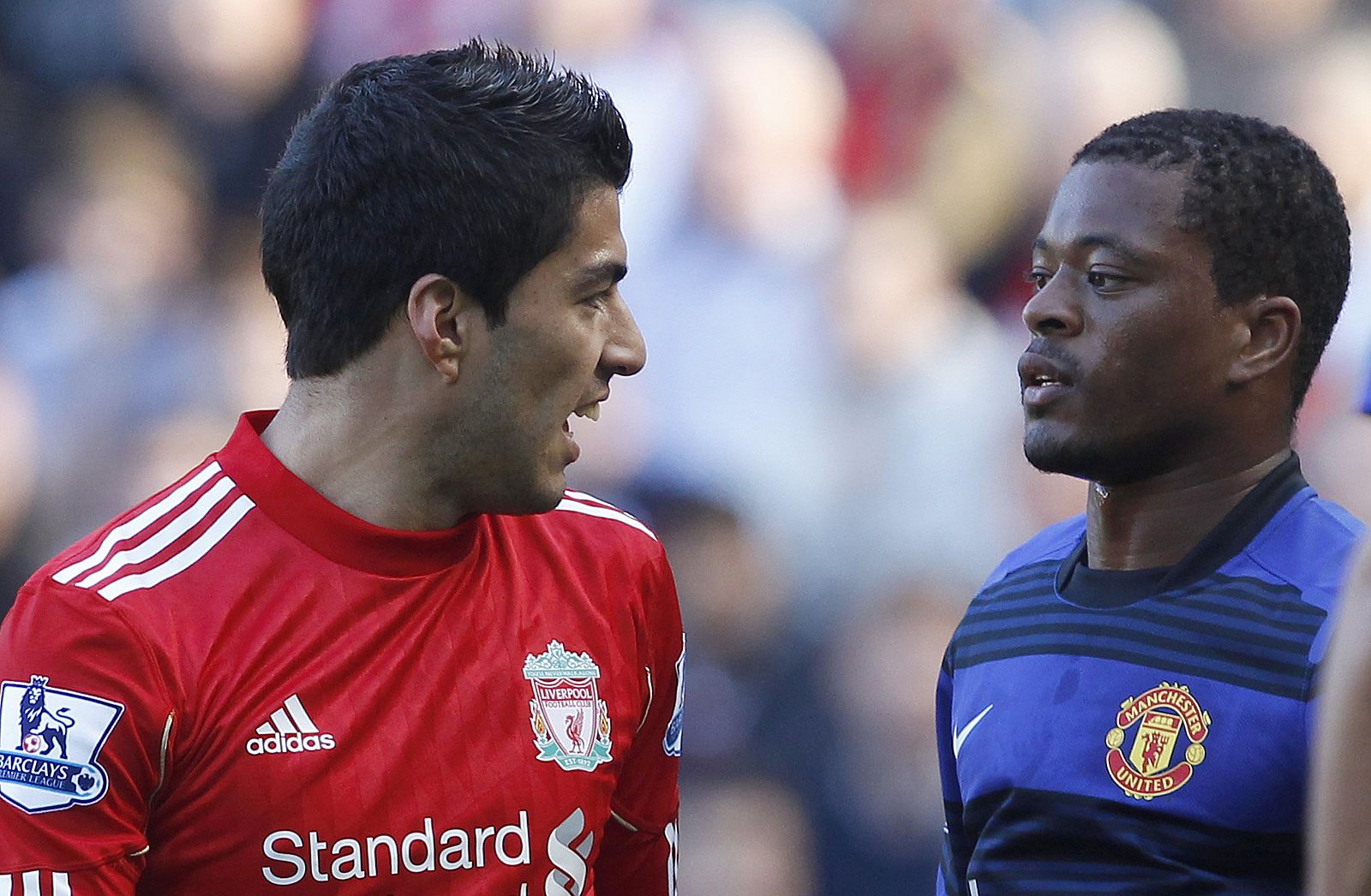 File photo of Liverpool's Suarez and Manchester United's Evra looking at each other during their English Premier League soccer match at Anfield in Liverpool