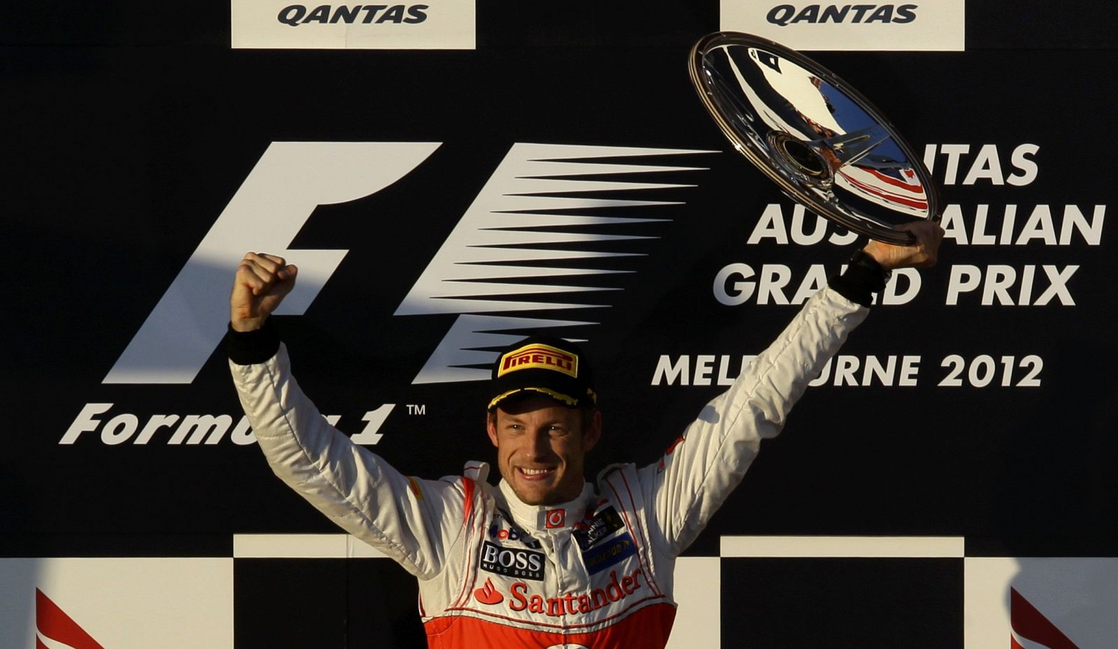 McLaren Formula One driver Button celebrates his victory on the podium after the Australian F1 Grand Prix at the Albert Park circuit in Melbourne