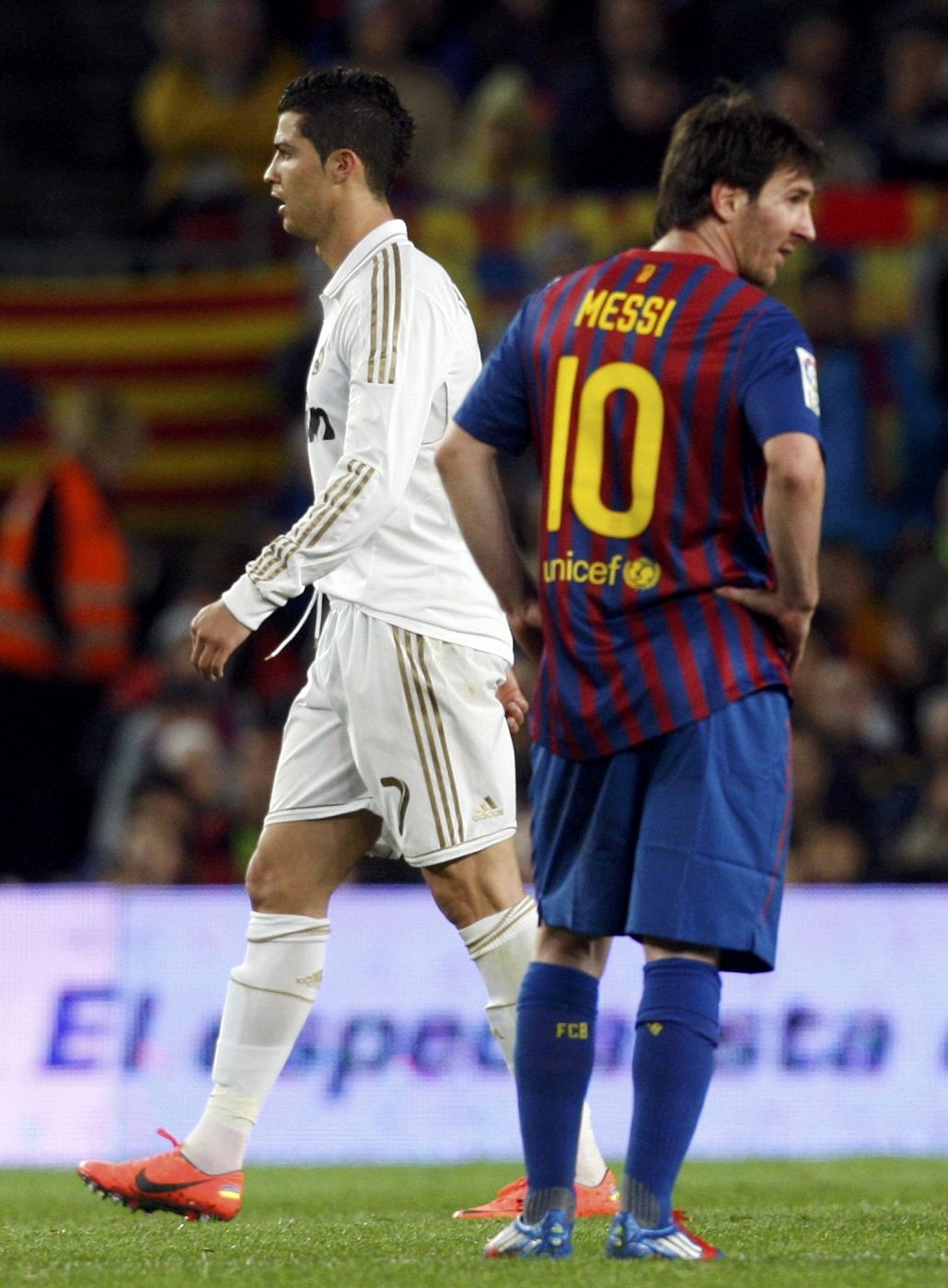 Real Madrid's Ronaldo walks past Barcelona's Messi after scoring his goal during their Spanish first division "El Clasico" soccer match