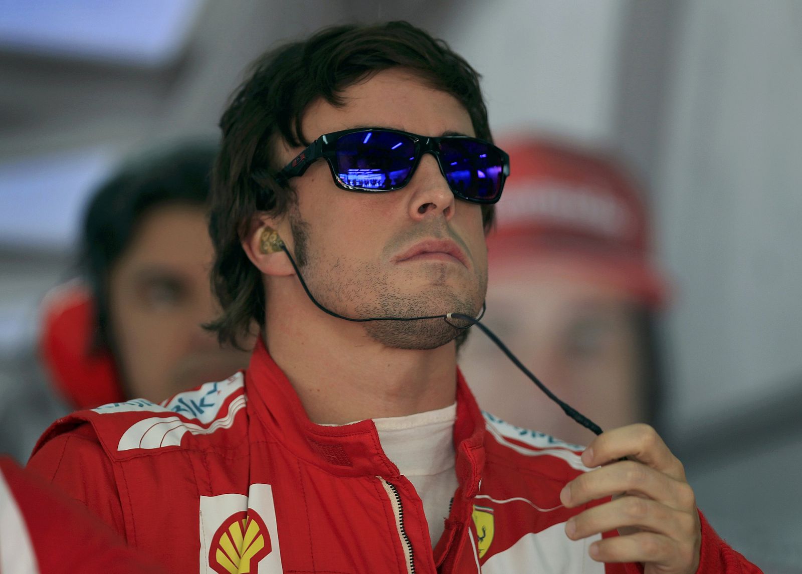 Ferrari Formula One driver Alonso looks at a monitor during the third practice session of the Bahrain F1 Grand Prix at the Sakhir circuit in Manama