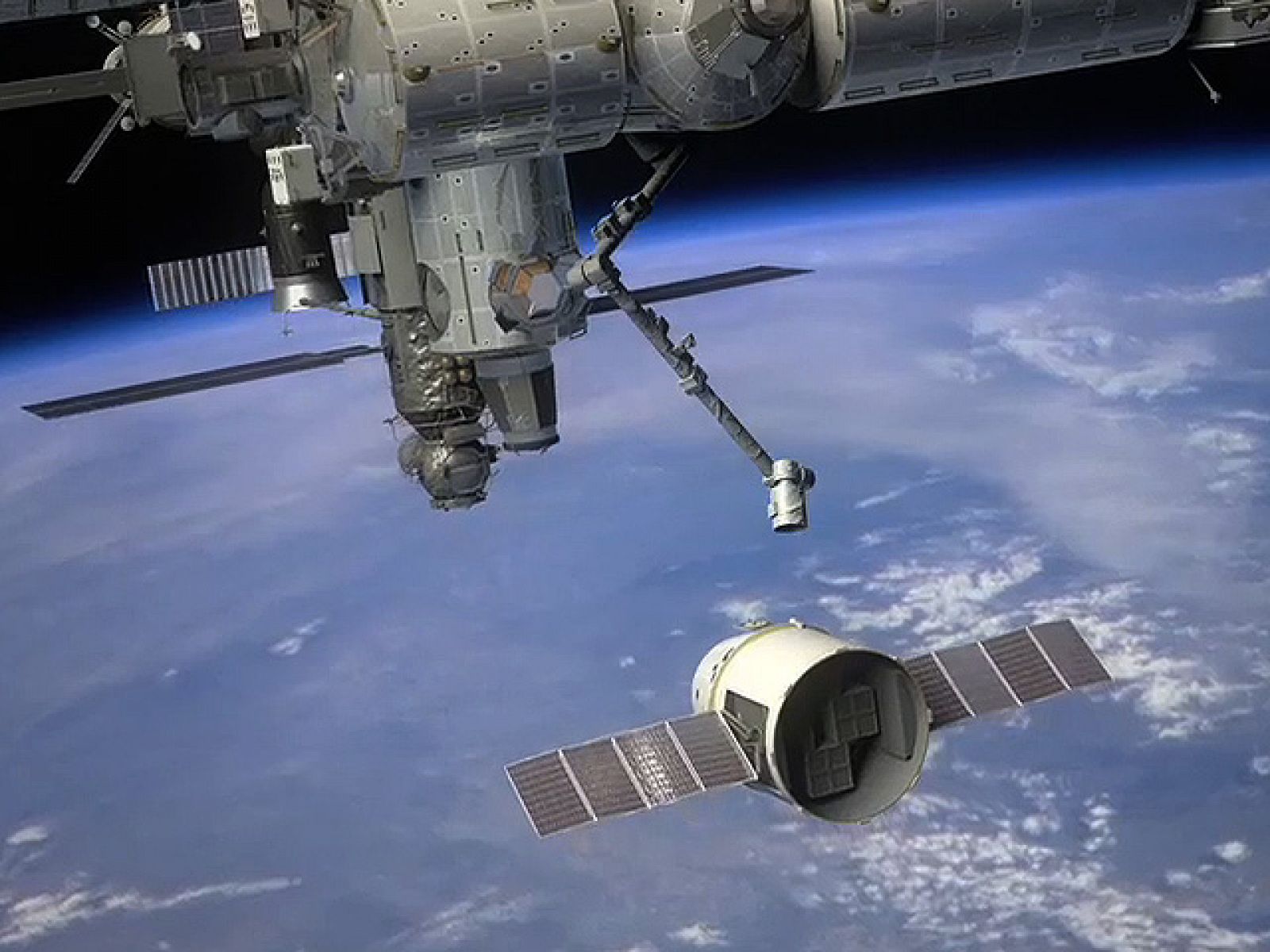 Impresión artística del brazo robot de la Estación Espacial Internacional capturando la Dragon
