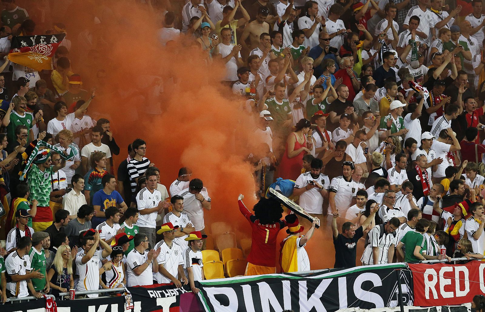 Fanáticos alemanes usan una columna de humo en la tribuna para animar a su equipo ante Dinamarca