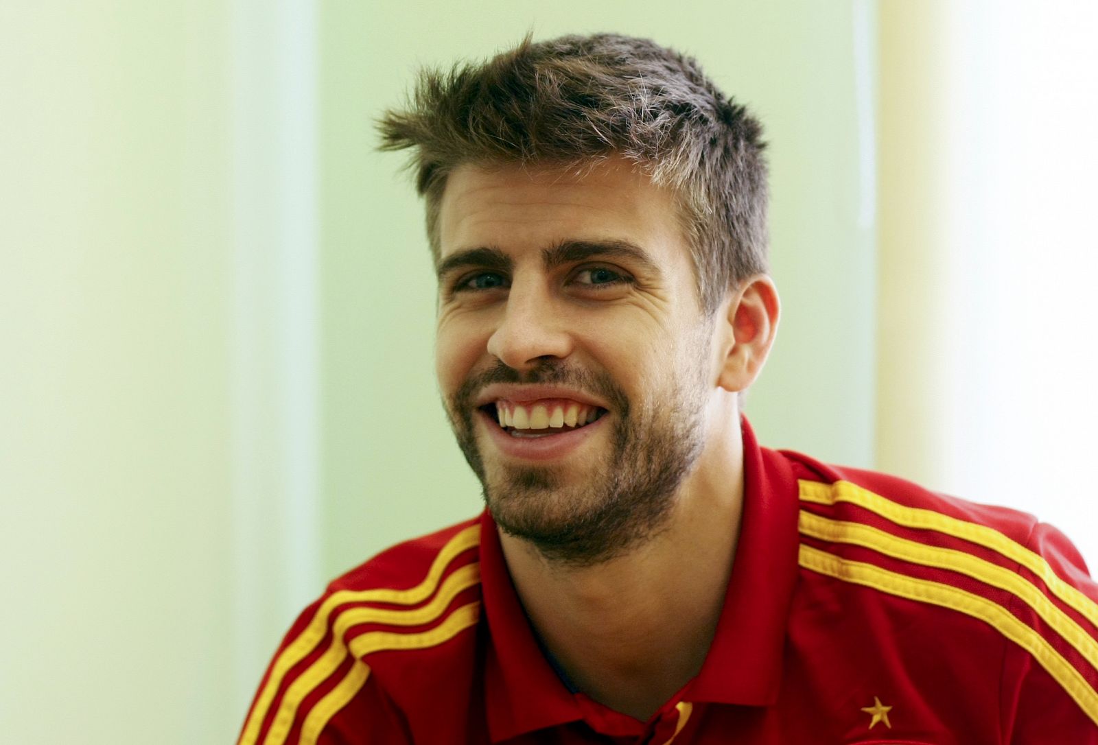 Spain's national soccer player Pique smiles during an interview with Reuters media during the Euro 2012 soccer tournament in Gniewino