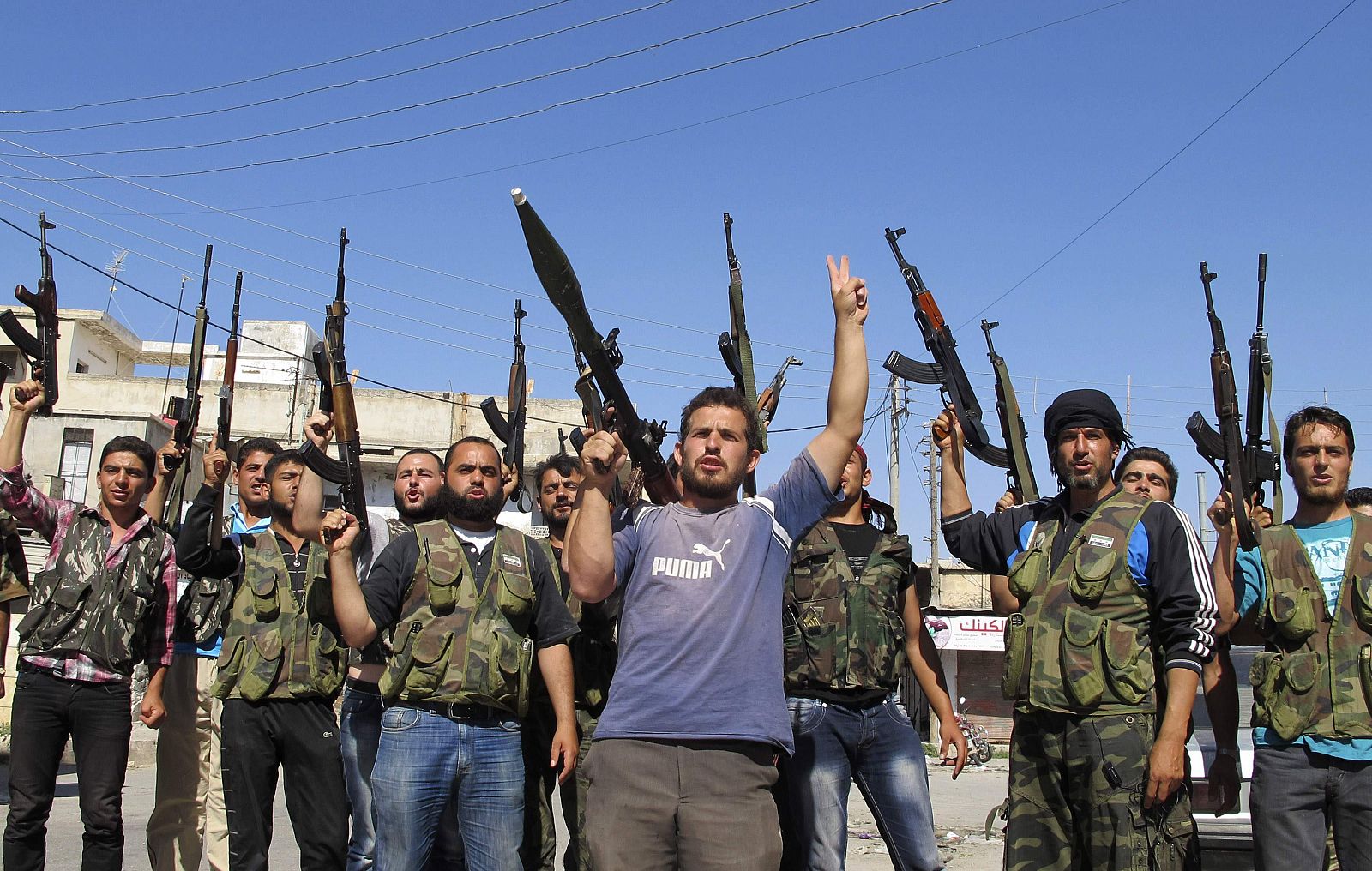 Members of the Free Syrian Army chant slogans against Syrian President Bashar al-Assad in Azzaz