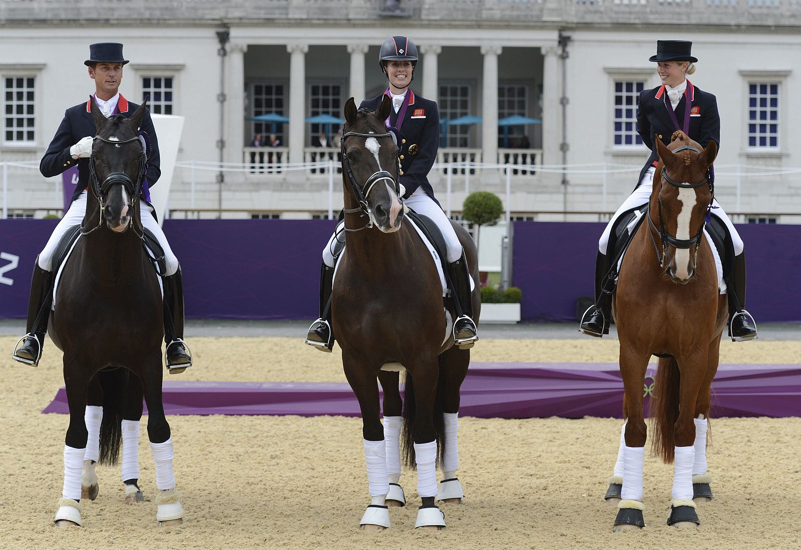 El equipo británico de equitación (Carl Hester, Laura Bechtolsheimer y  Charlotte Dujardin) celebra la medalla de oro conseguida en la final del Gran Premio de Doma Clásica de los Juegos Olímpicos.
