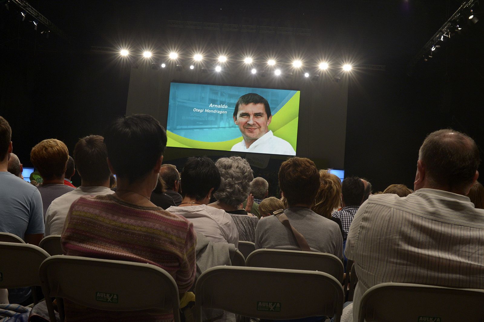 Supporters listen to a recorded speech by jailed Basque nationalist leader Arnaldo Otegi during a campaign rally by pro-independence party Euskal Herria Bildu (EH Bildu) at the Bilbao Exhibition Centre in Barakaldo