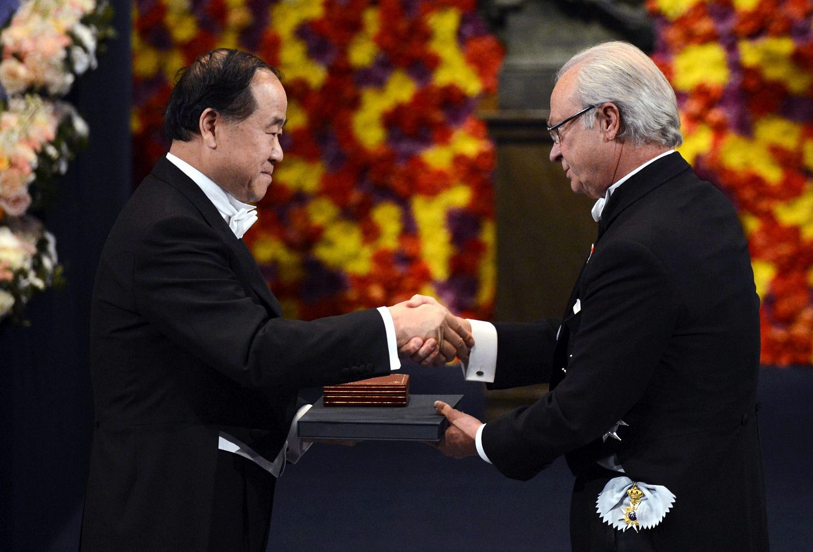 Winner of the 2012 Nobel Prize for Literature Mo Yan of China smiles as he receives his prize from Sweden's King Carl XVI Gustaf during the Nobel Prize award ceremony at the Stockholm Concert Hall in Stockholm