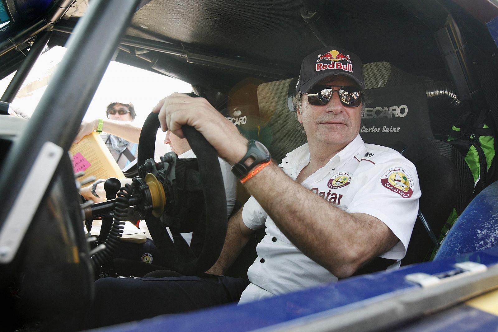 Spain's Sainz sits in his buggy after passing the technical verification exercise of the Dakar Rally 2013 at Magdalena beach in Lima