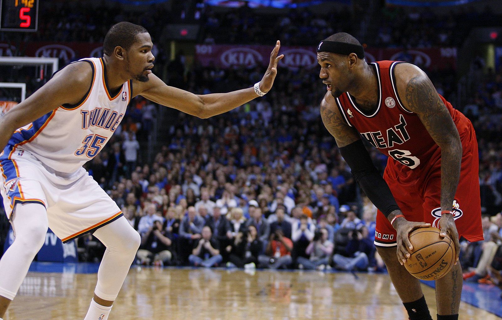 Miami Heat forward LeBron James faces off against Oklahoma City Thunder forward Kevin Durant in the first half of their NBA basketball game in Oklahoma City.