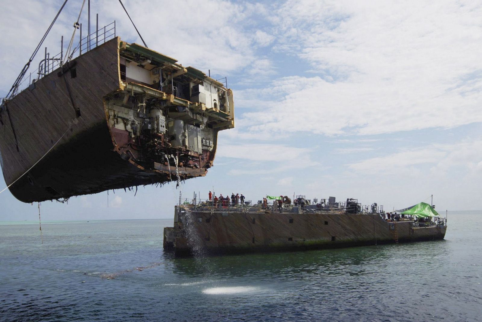 Uno de las secciones del buque estadounidense USS Guardian es retirado del fondo del mar de Filipinas