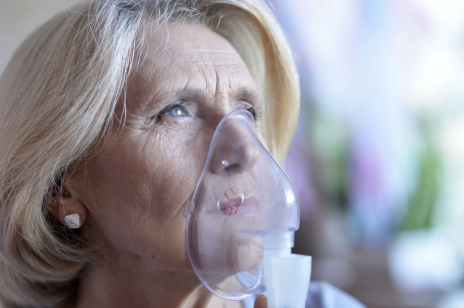 Mujer inhalando oxígeno.