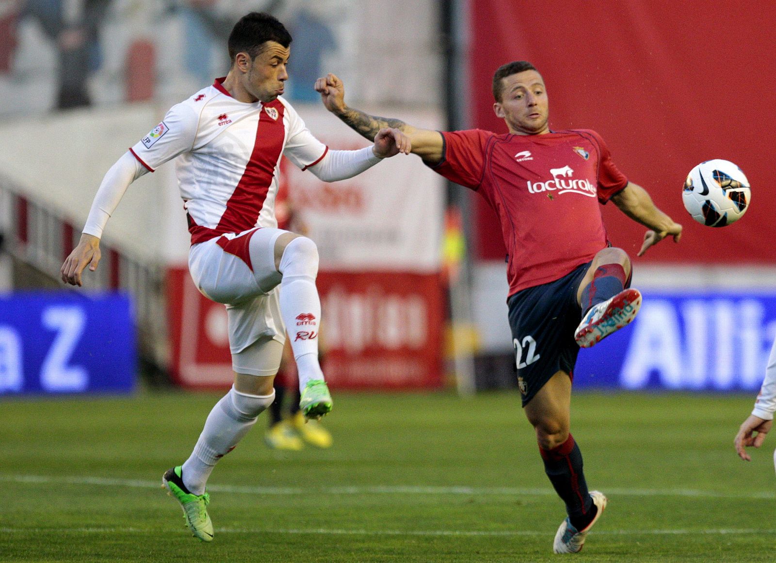 El centrocampista del Osasuna David Timor disputa un balón con el centrocampista del Rayo Vallecano Javi Fuego.