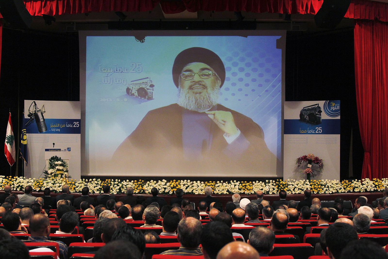 Lebanon's Hezbollah leader Nasrallah is projected on a screen during a live broadcast at an event marking the 25th anniversary of the establishment of Al-Nour radio station in Beirut