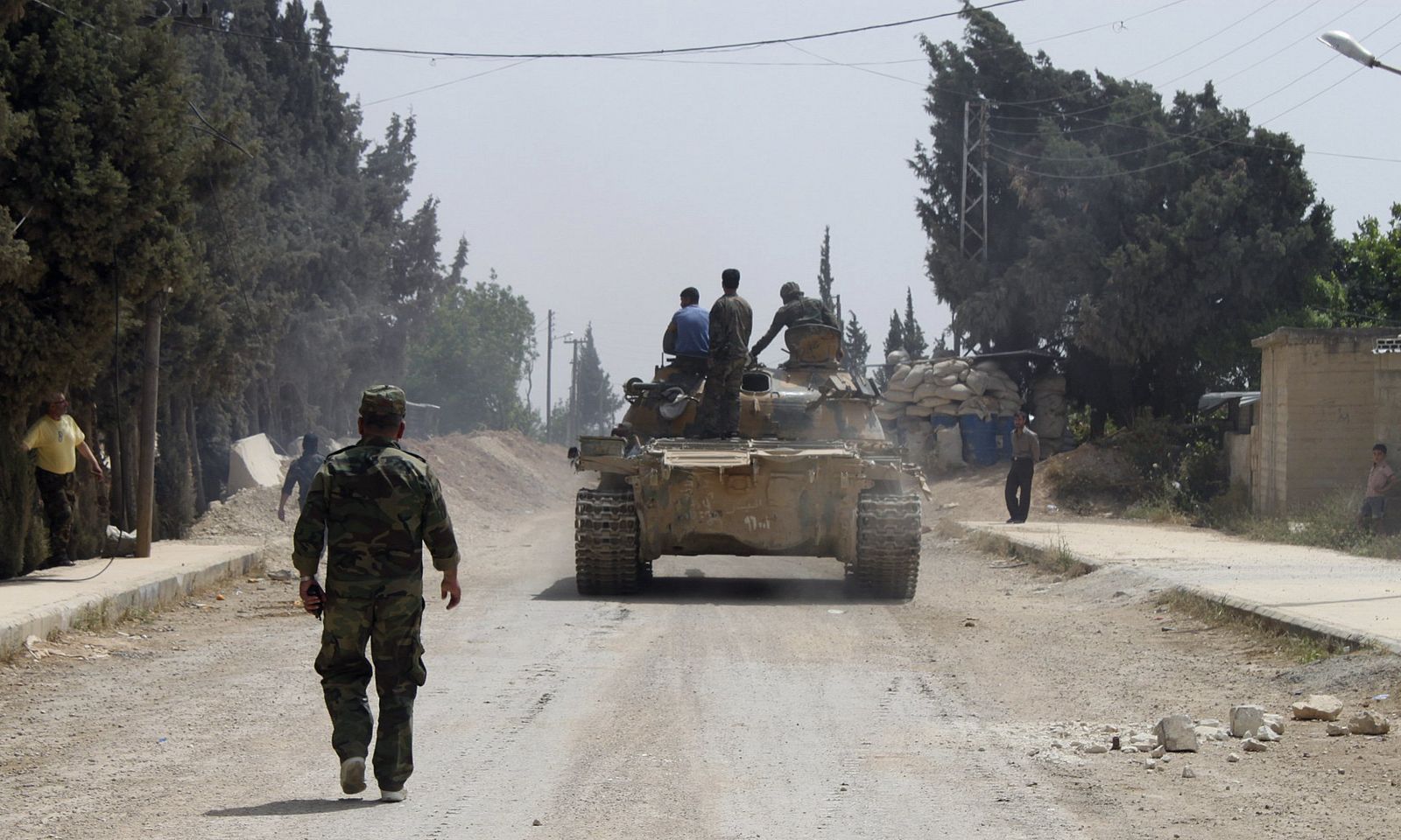 Forces of Syrian President Bashar al-Assad are seen in Arjoun village near Qusair town