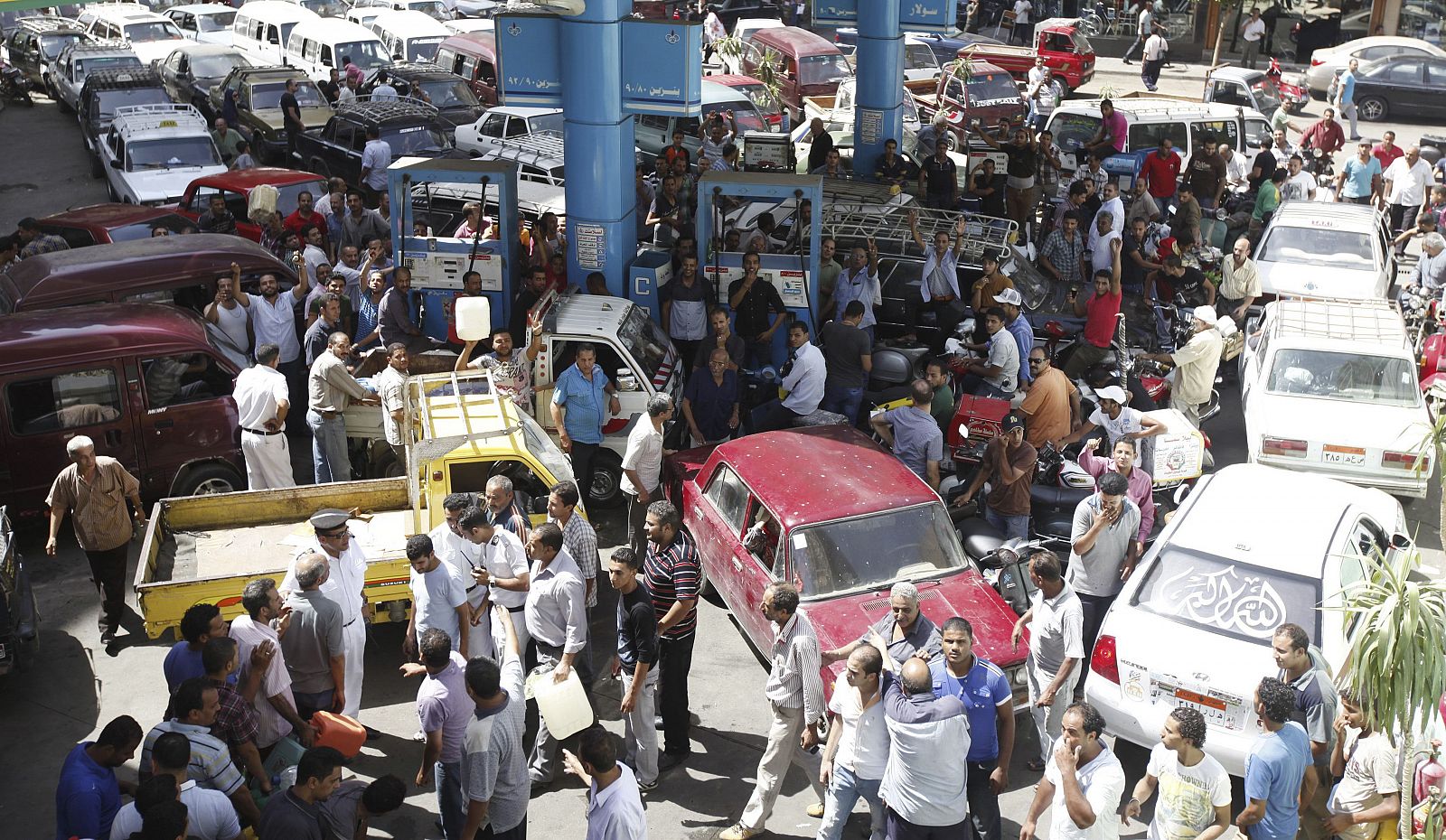 People crowd around a petrol station during a fuel shortage in Cairo