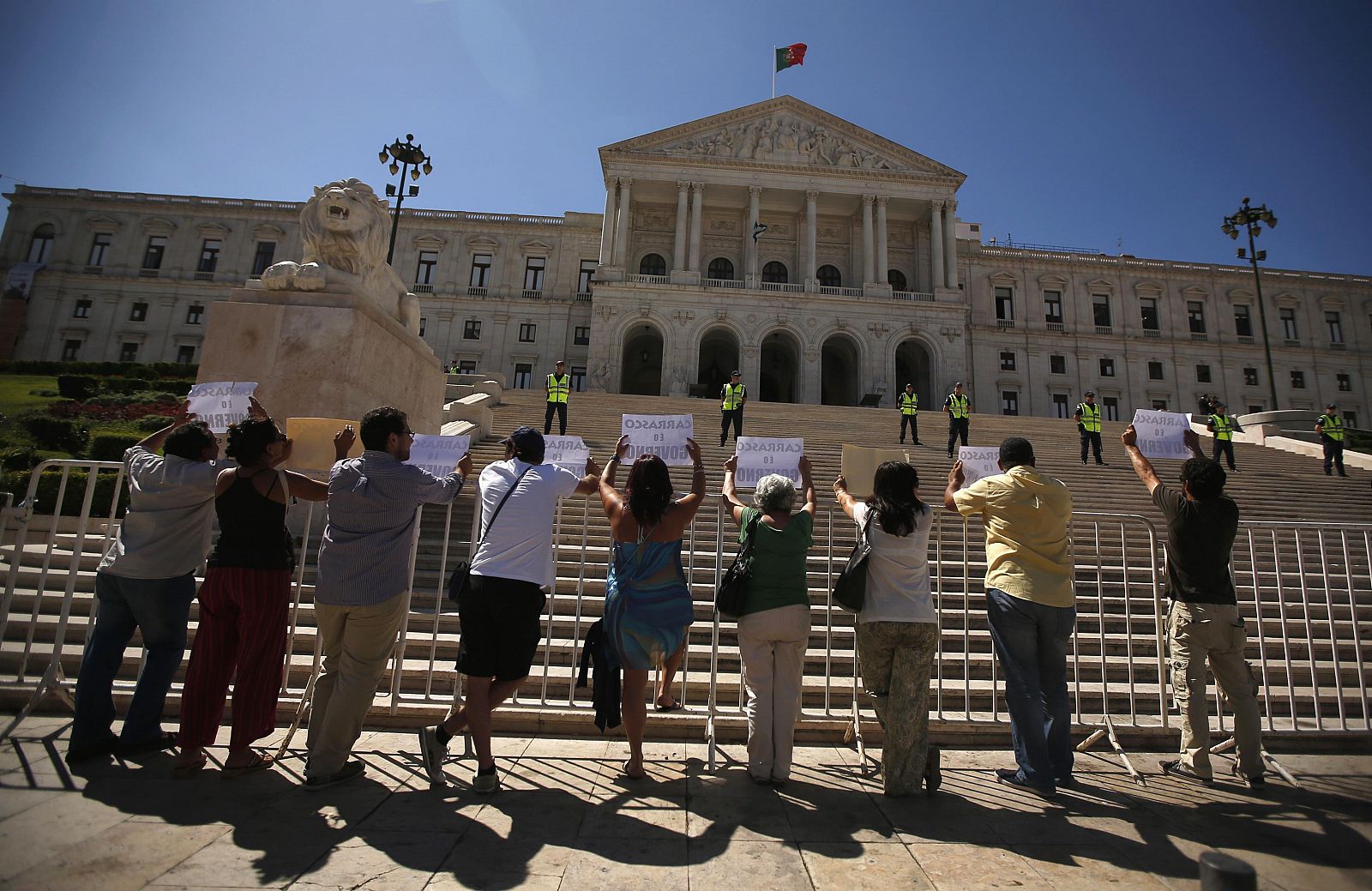 Un grupo de manifestantes sujeta unas pancartas en una protesta ante el parlamento portugués contra la reforma en la función pública.