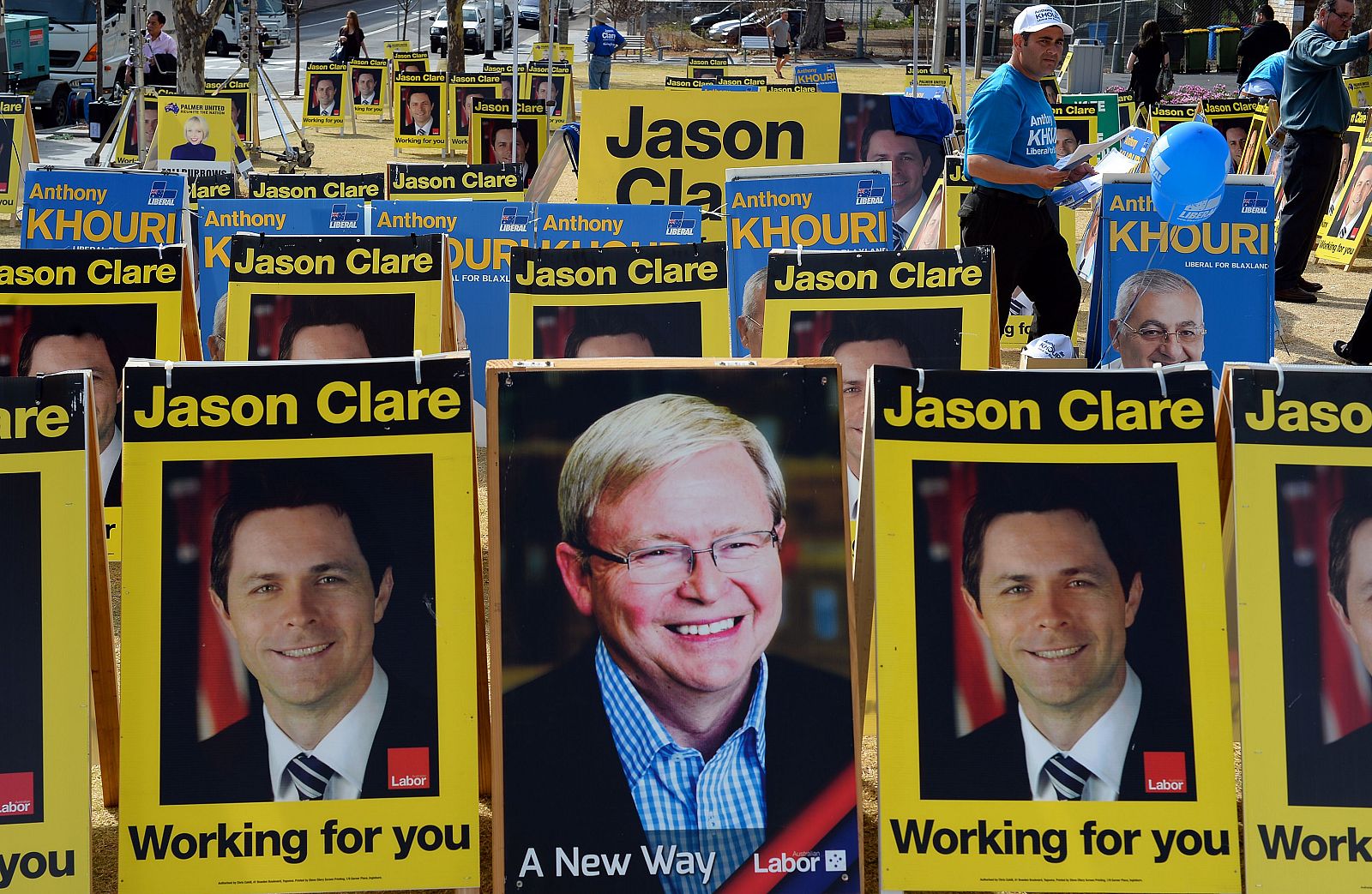 Un hombre camina tras los carteles de los candidatos a las elecciones en Australia.