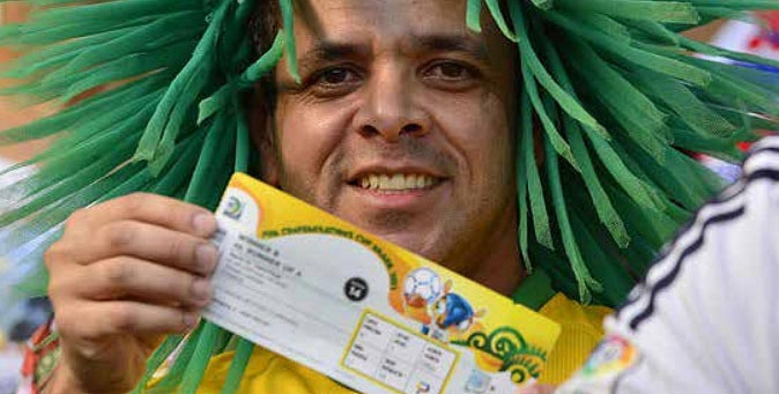 Un aficionado brasileño muestra orgulloso su entrada para el Mundial.
