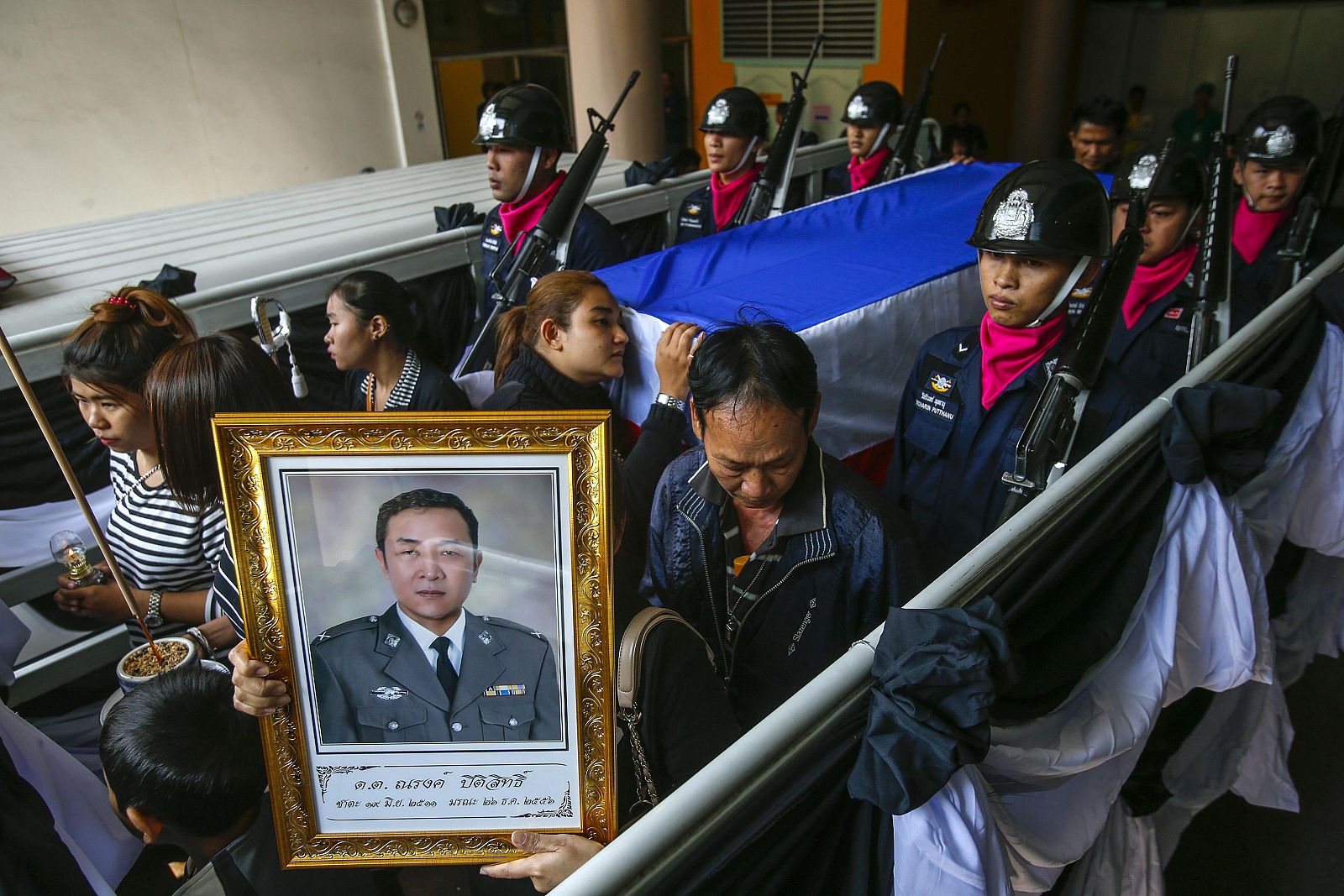 Familiares en el funeral del policía muerto en las protestas de Tailandia el jueves