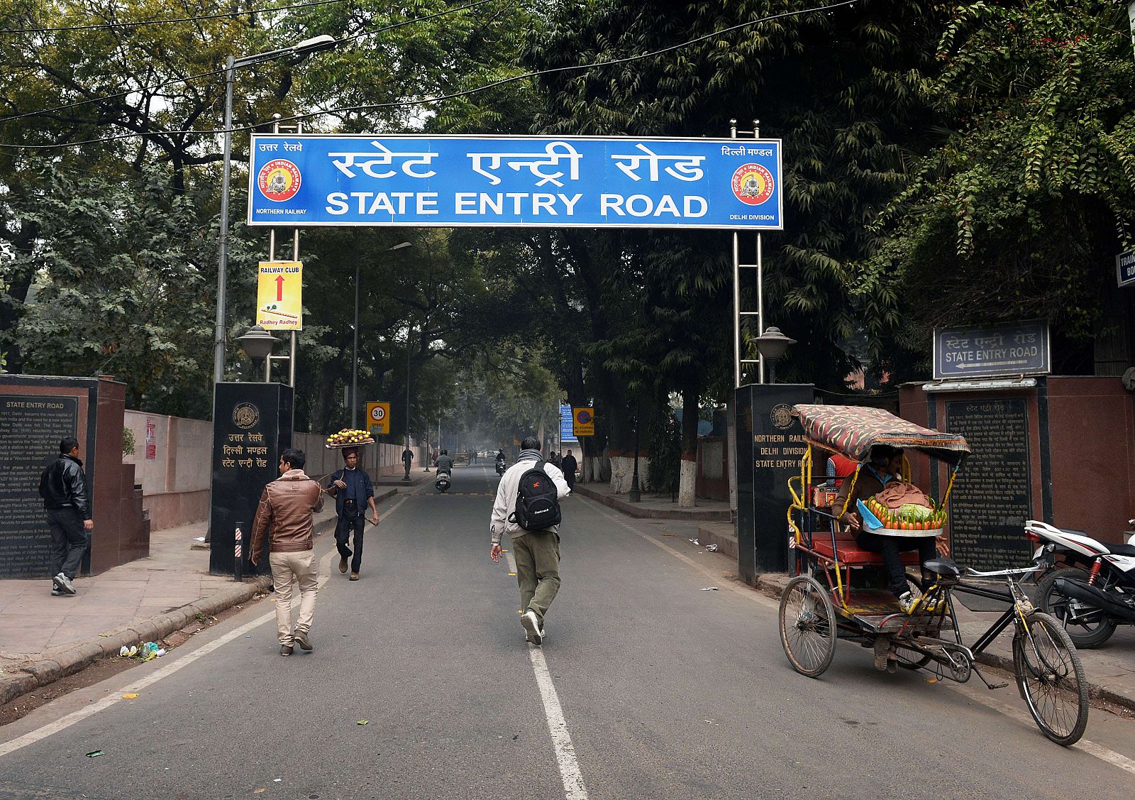 Varios hombres caminan hacia la entrada del parque donde una turista danesa denunció ser violada en Nueva Delhi.