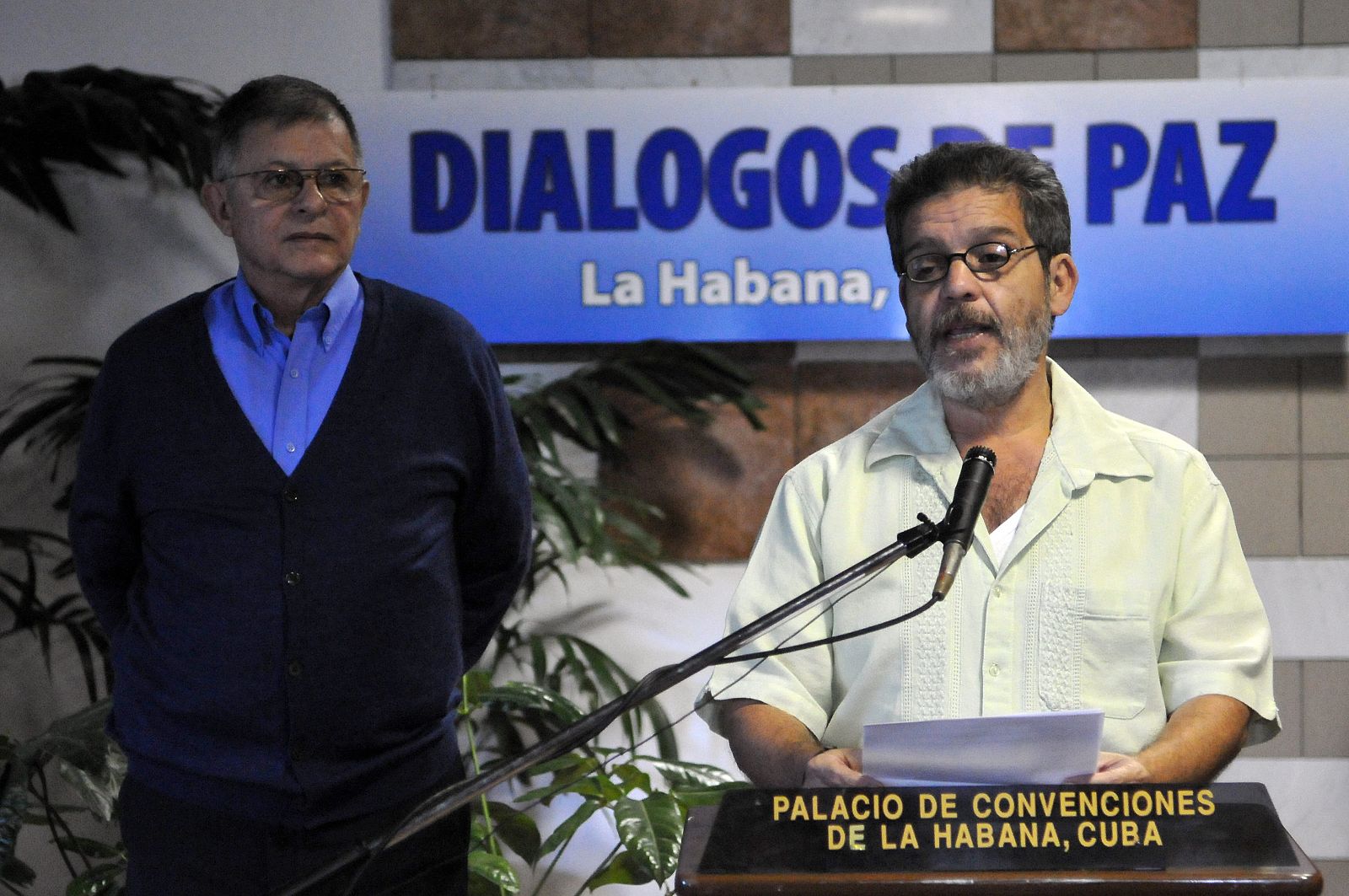 El miembro del equipo negociador de las FARC Luis Alberto Albán (d), acompañado de Rodrigo Granda (i), lee un comunicado previo a una nueva jornada de diálogos de paz.