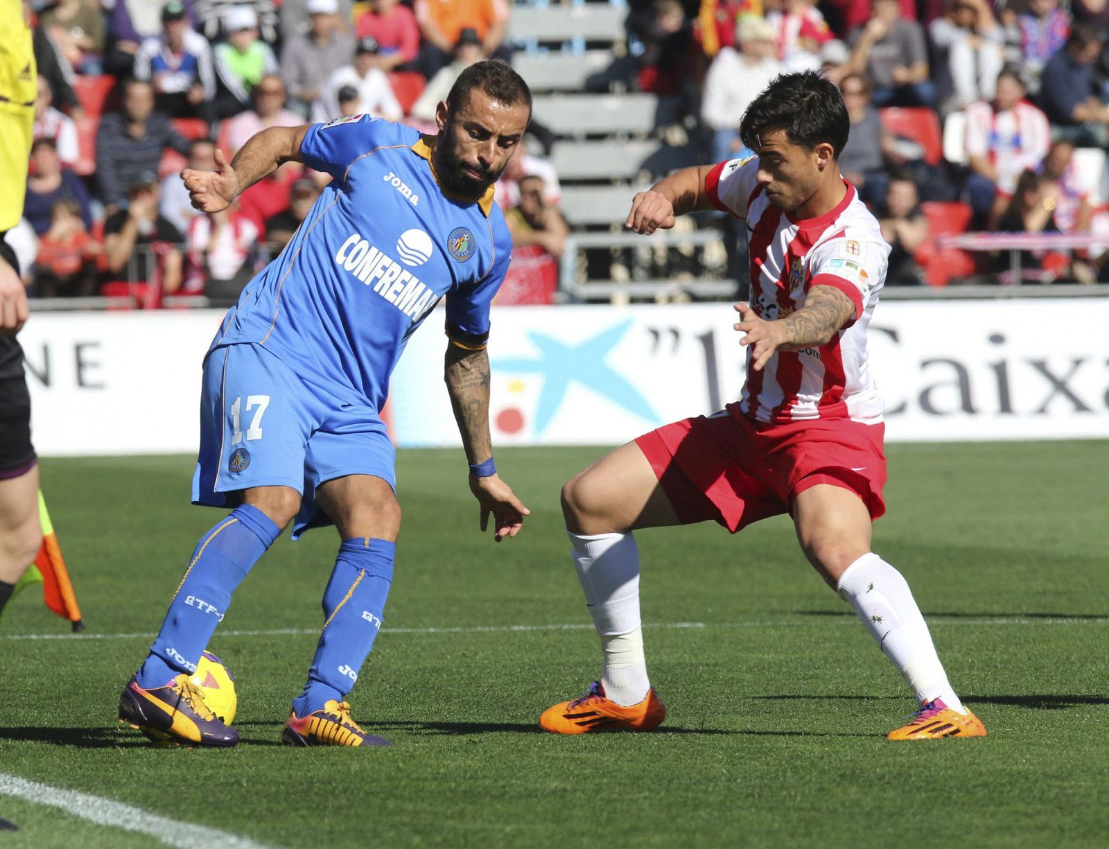 El centrocampista del Getafe, Diego Castro (i), intenta controlar el balón ante el centrocampista del Almería, Jesús Fernández "Suso" (d)
