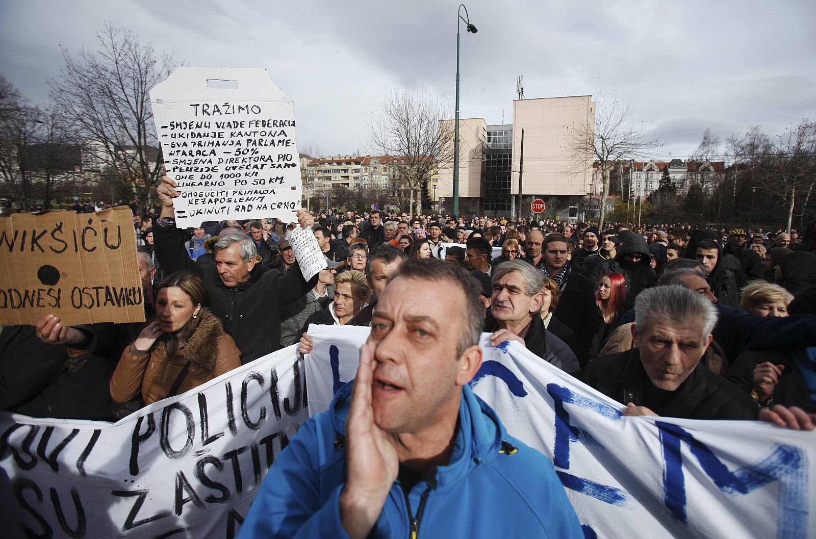 Anti-government protesters rally in front of a government building in Sarajevo