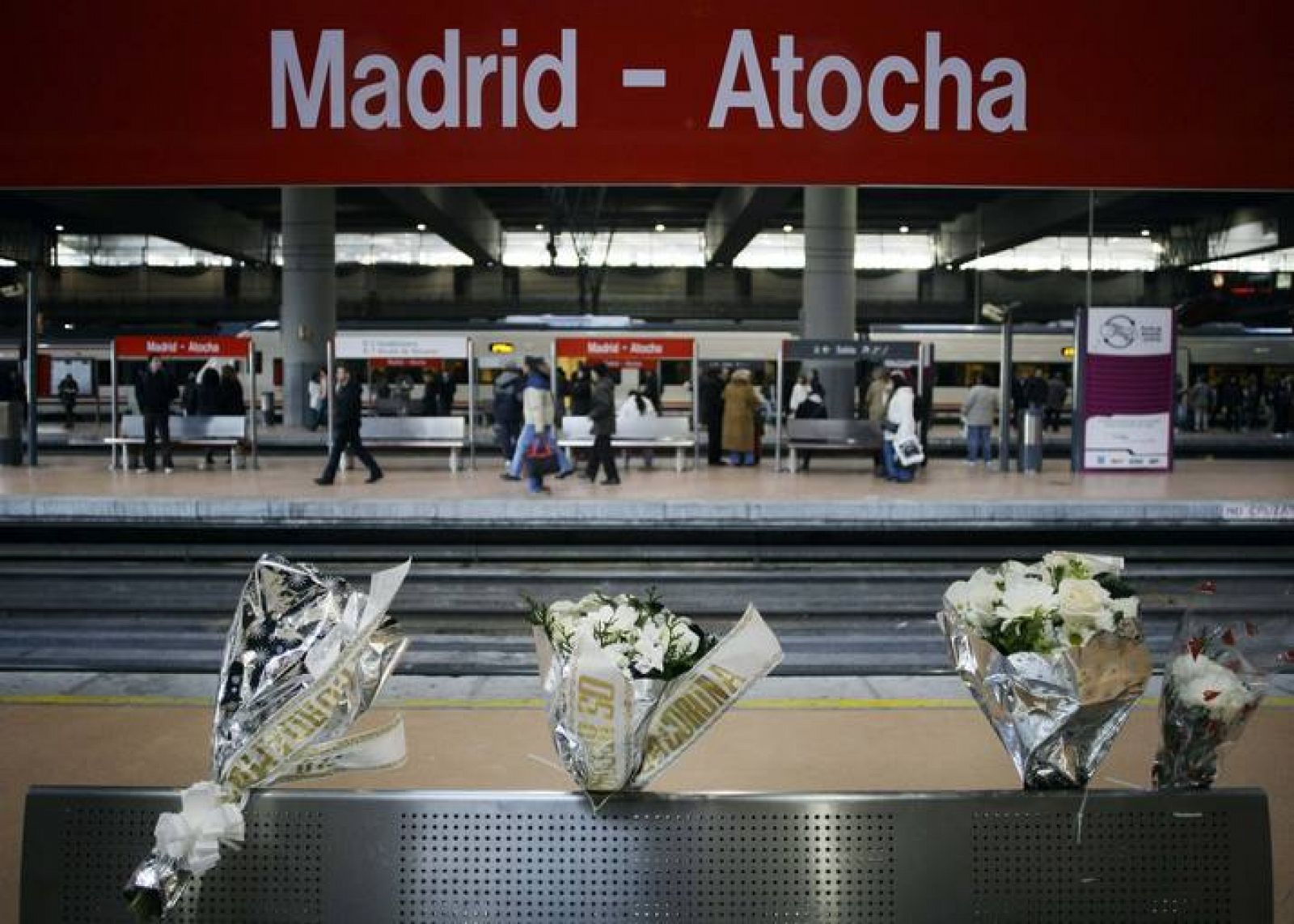 Bouquets of flowers are placed at Madrid's Atocha station on the sixth anniversary of the Madrid train bombings