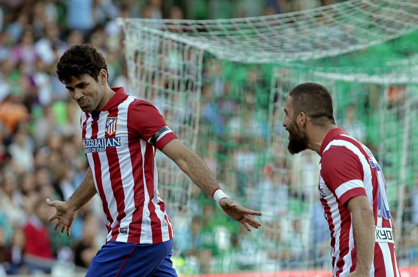 El delantero del Atlético de Madrid Diego Costa (i) celebra con su compañero Arda Turan (d), tras marcar gol ante el Betis