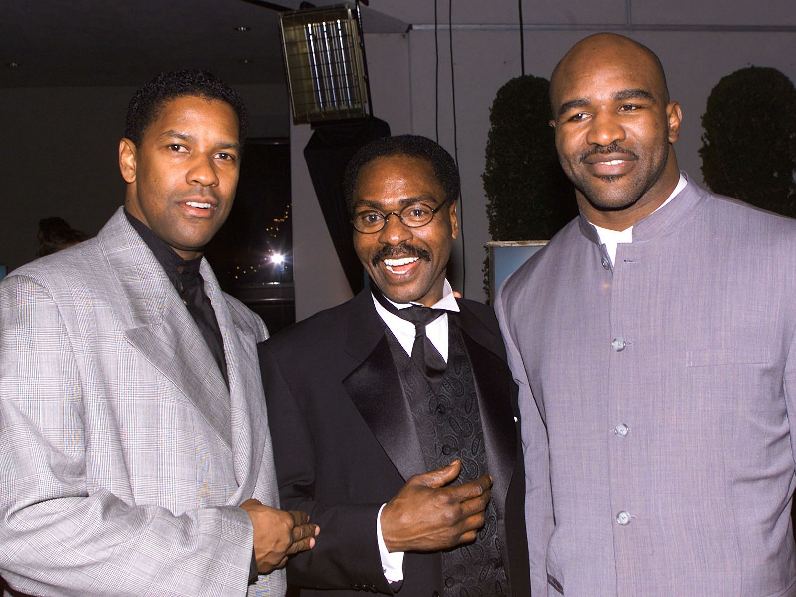File photo of Rubin Carter posing with Washington and Holyfield at premiere of The Hurricane in Los Angeles