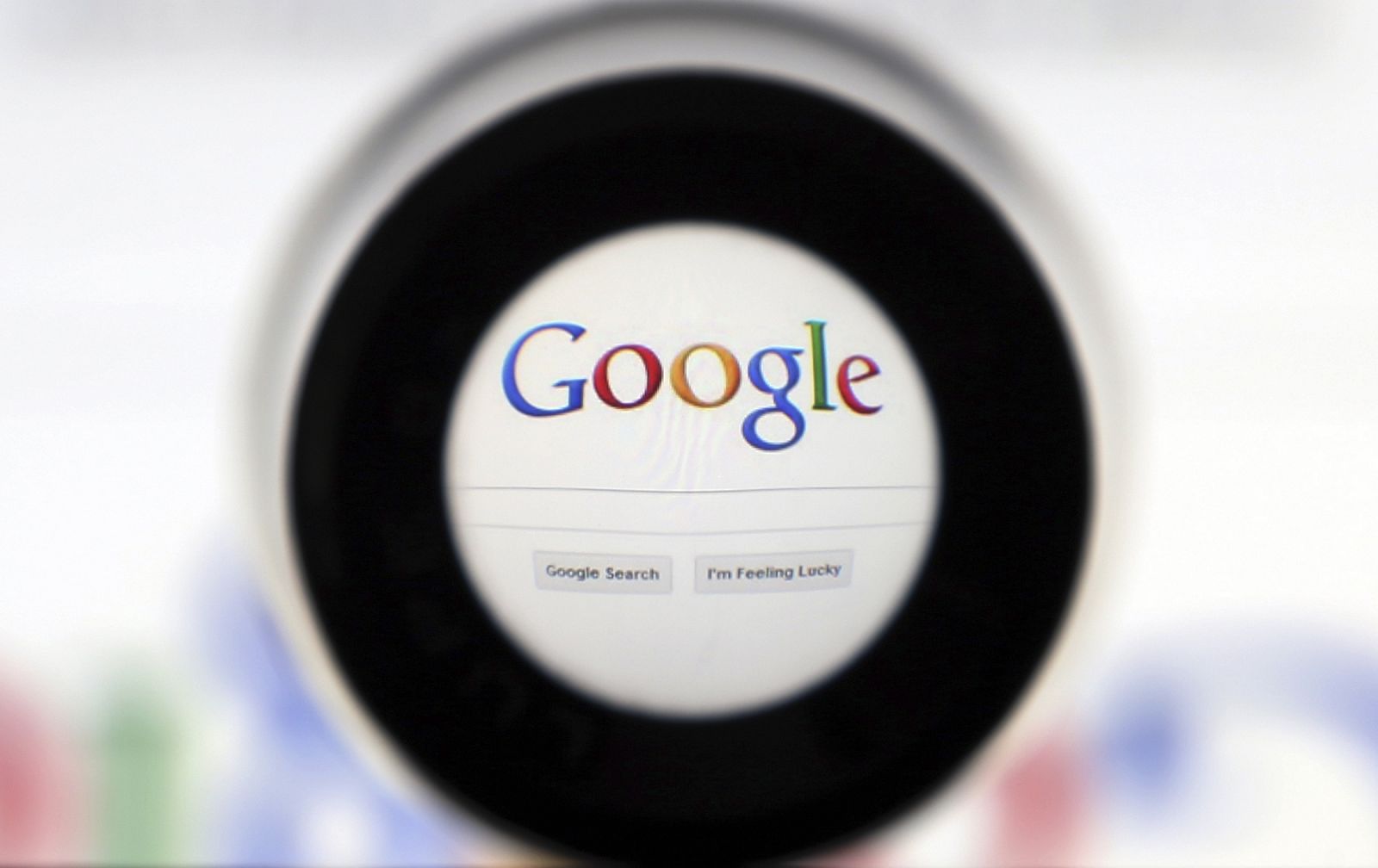 A Google search page is seen through a magnifying glass in this photo illustration taken in Brussels