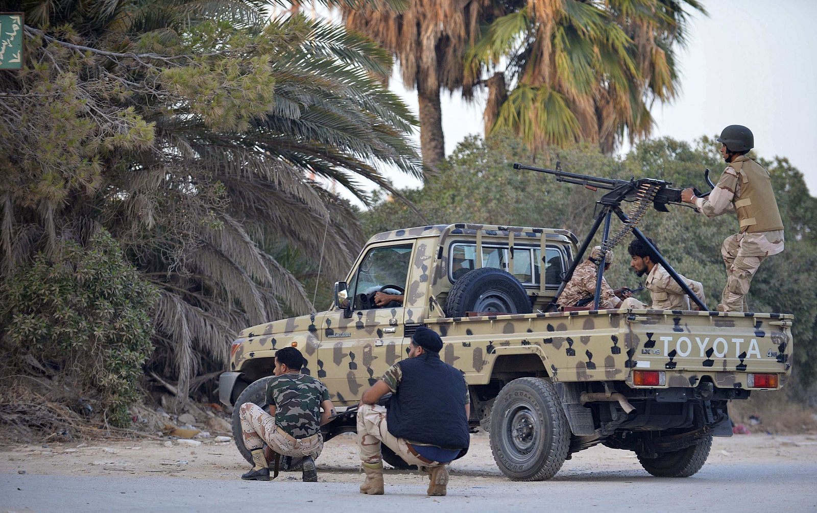 Irregular forces loyal to former army general Khalifa Haftar stand by an armed vehicle during clashes with Islamist militants in the eastern city of Benghazi