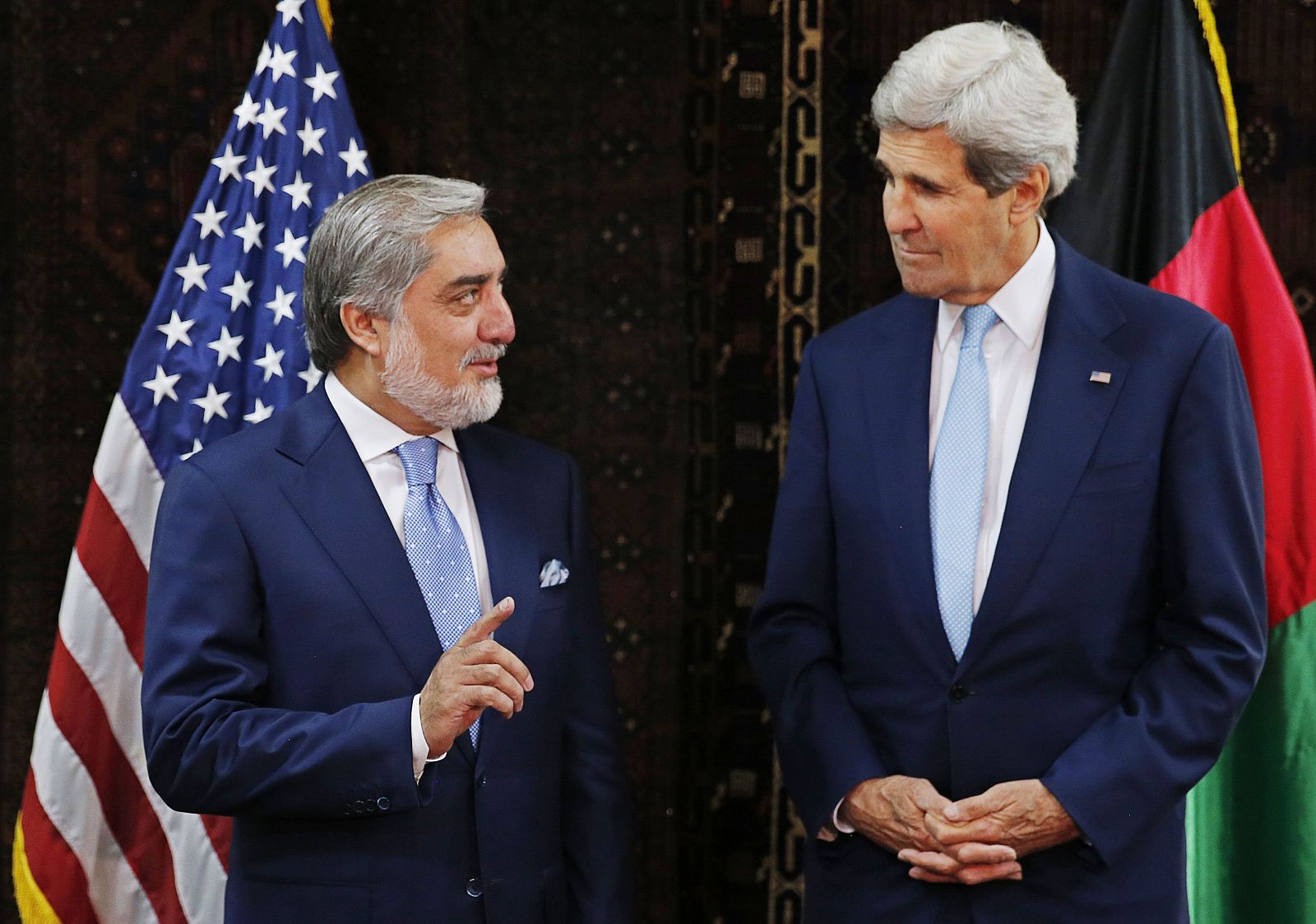 Afghanistan's presidential candidate Abdullah speaks to U.S. Secretary of State Kerry at the start of a meeting at the U.S. embassy in Kabul