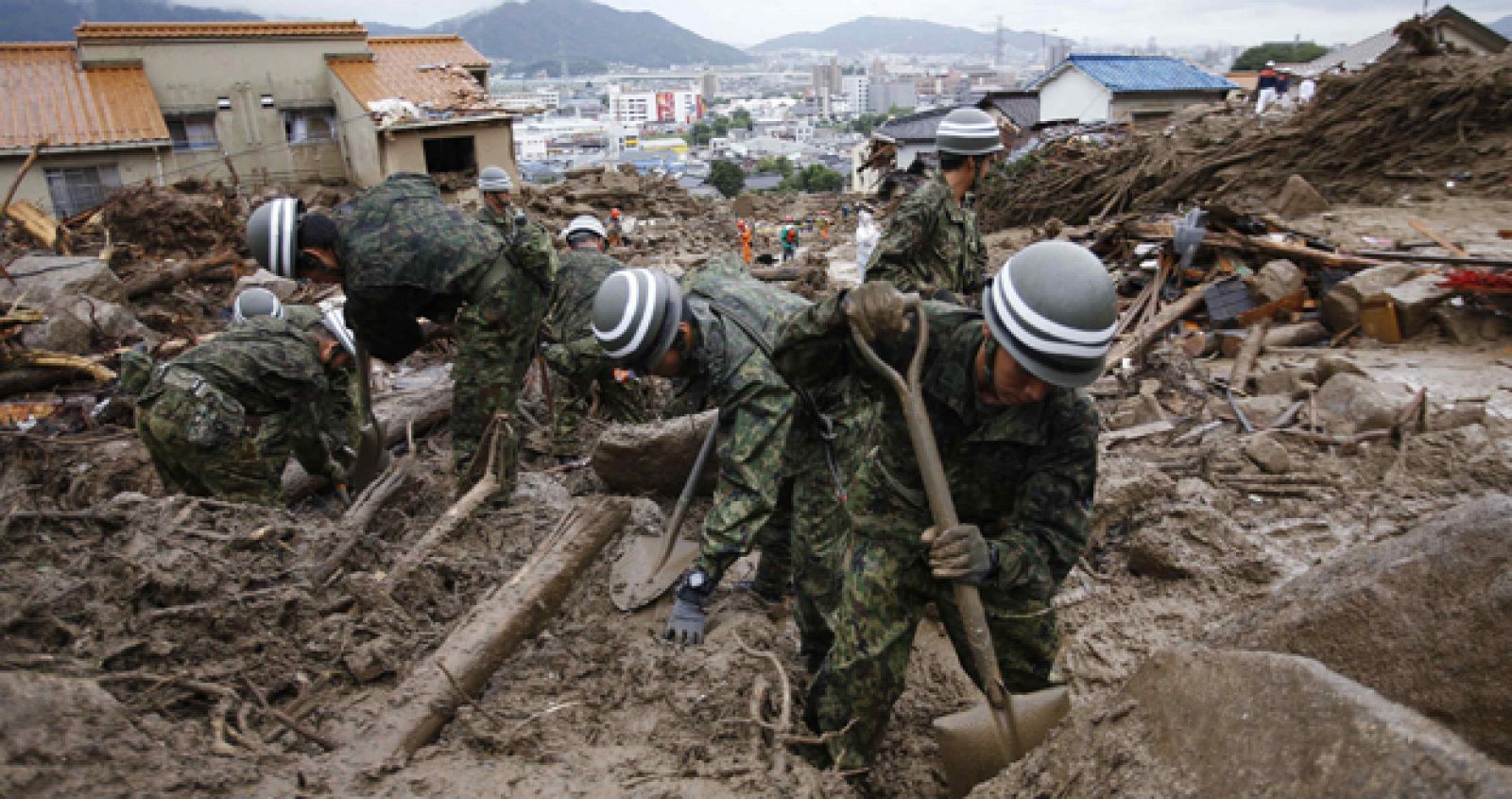 JSDF soldiers search for survivors in the rain at a site where a landslide swept through a residential area at Asaminami ward in Hiroshima