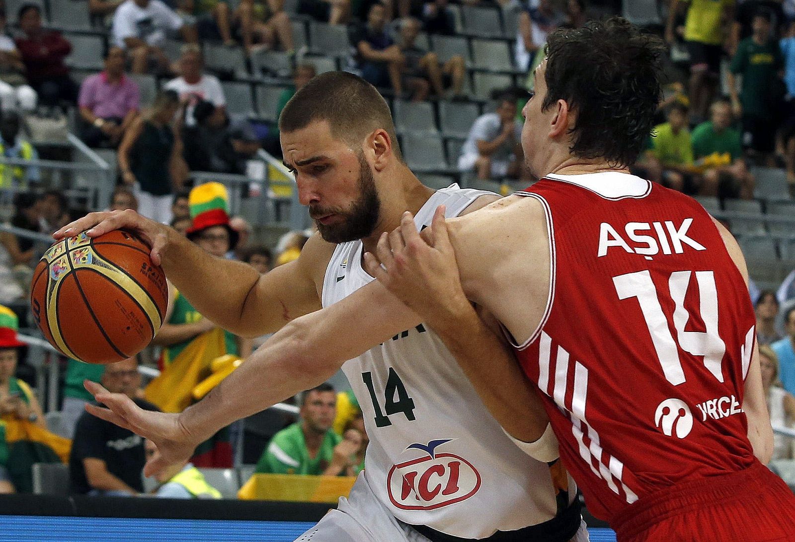 El jugador de Lituania, Jonas Valanciunas (i), intenta avanzar ante la defensa de Ömer Asik, de Turquia