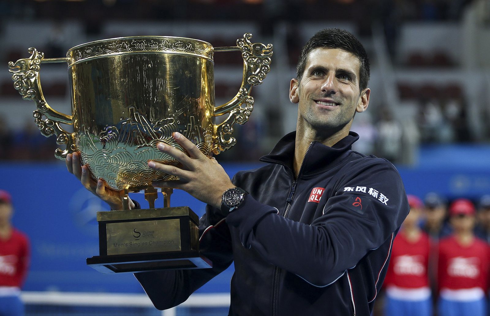 Djokovic of Serbia holds his trophy as he poses for pictures after winning the men's singles final match against Berdych of the Czech Republic at the China Open tennis tournament in Beijing