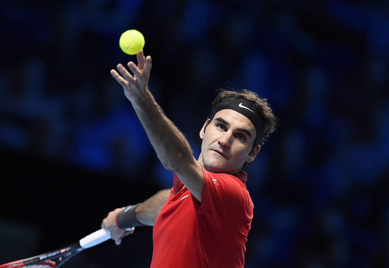 Federer of Switzerland serves during his men's singles tennis match against Raonic of Canada at the ATP World Tour Finals at the O2 Arena in London