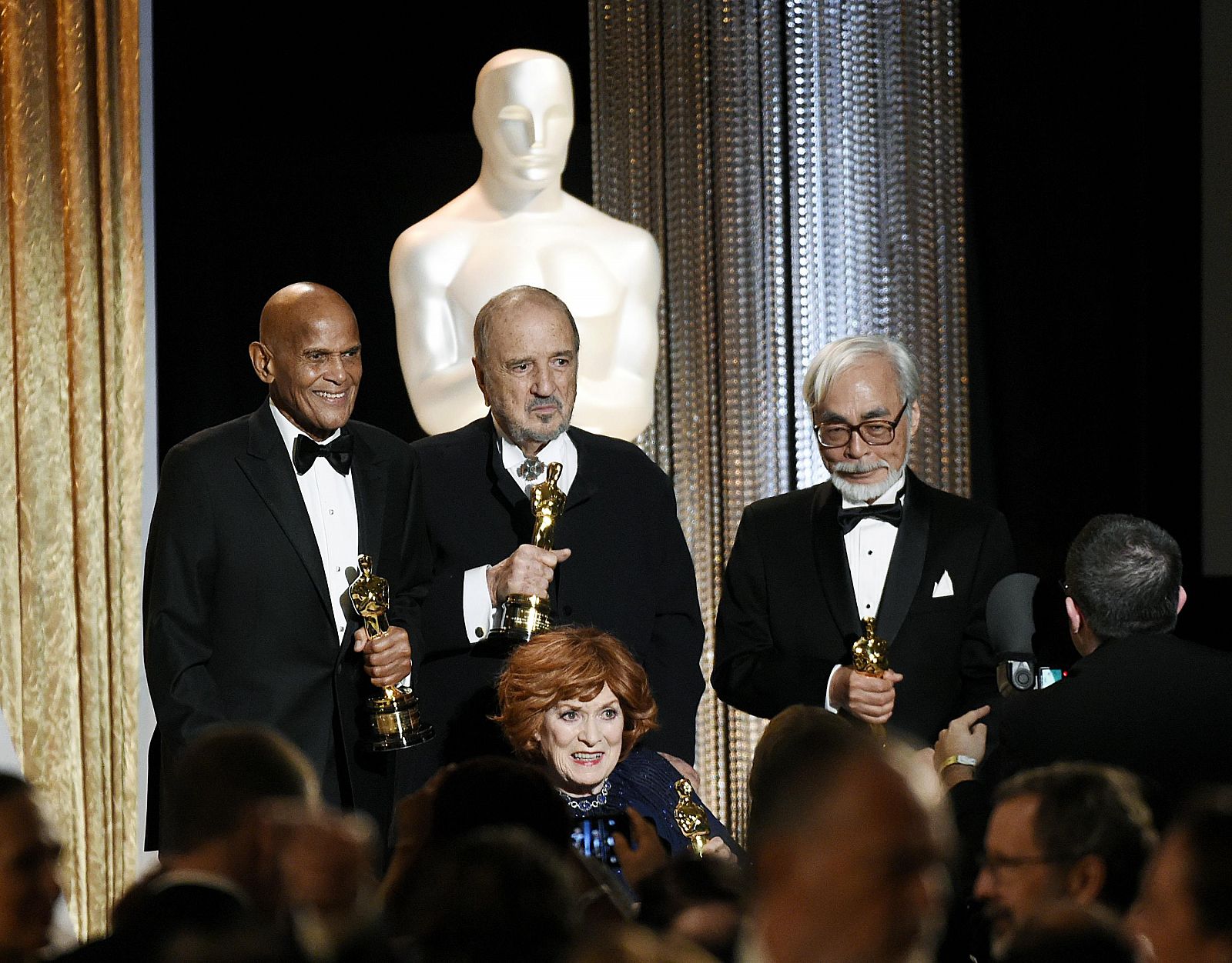 Singer and social activist Belafonte, holding the Jean Hersholt Humanitarian Award, screenwriter Carriere, actress O'Hara and Japanese film director and animator Miyazaki pose onstage at the Academy of Mot